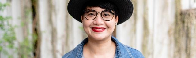 Asian woman with glasses, smiling