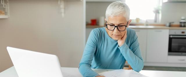 Woman at desk reviewing finances