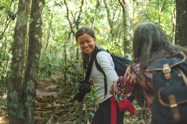 Two women hiking through forest 